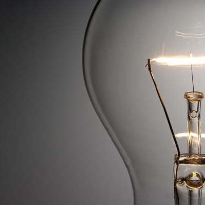 Close-up shot of illuminated light bulb with copy space